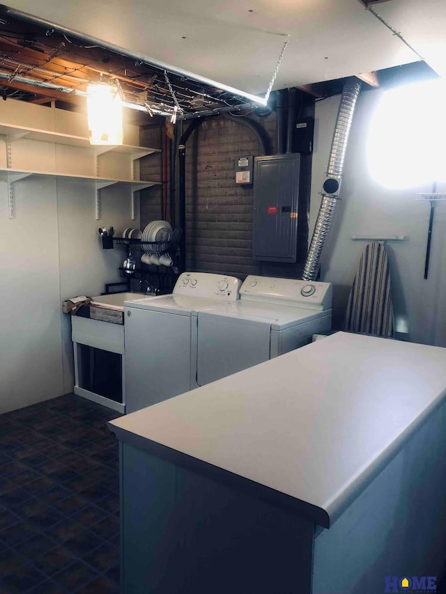 washroom featuring washing machine and clothes dryer and electric panel