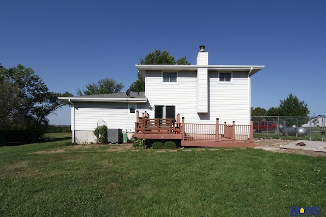 back of house with a yard, a deck, and central air condition unit