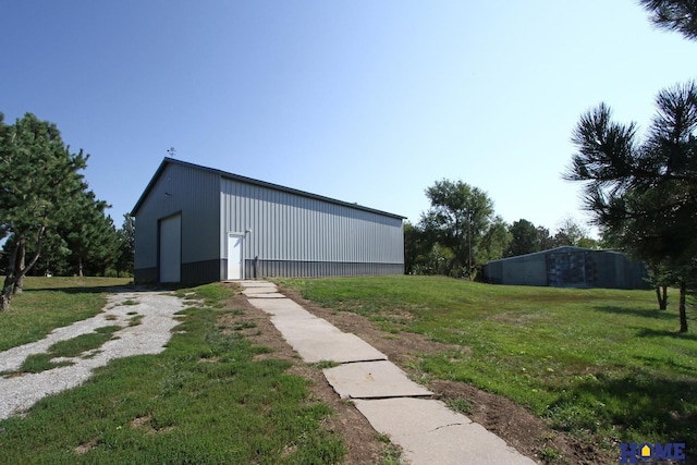 view of outdoor structure featuring a lawn