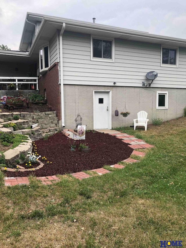 rear view of property with a yard