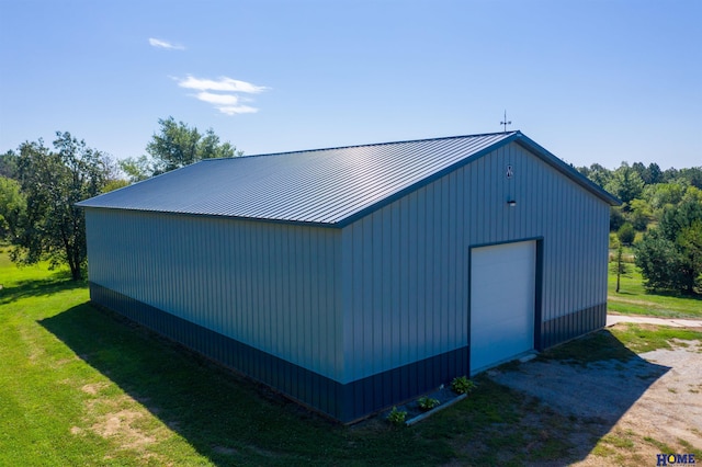 view of side of property featuring an outbuilding, a garage, and a lawn