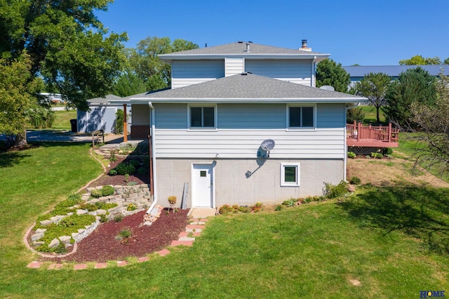 back of house with a wooden deck and a lawn