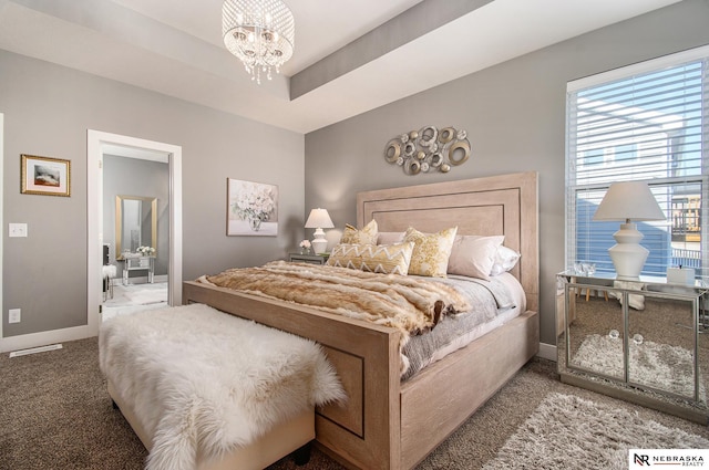 carpeted bedroom with a notable chandelier and a tray ceiling