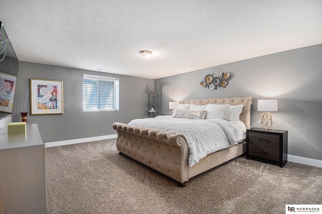 bedroom featuring carpet floors and a textured ceiling