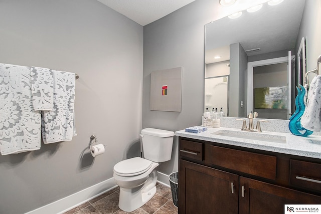 bathroom featuring vanity, toilet, and a shower with door