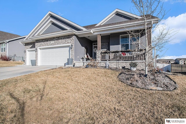 view of front of home with a porch, a garage, and a front yard