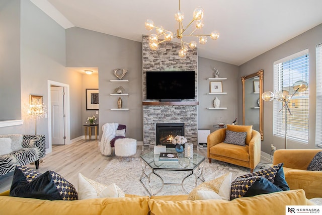 living room with wood-type flooring, a fireplace, and high vaulted ceiling