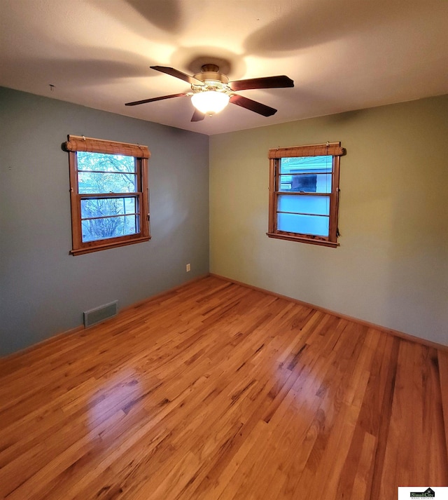 empty room featuring ceiling fan and light hardwood / wood-style flooring