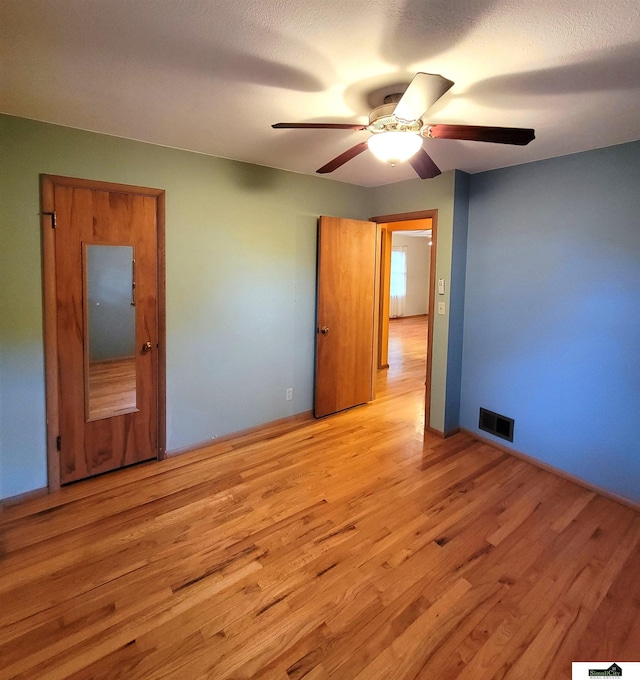 unfurnished bedroom with ceiling fan and light hardwood / wood-style flooring