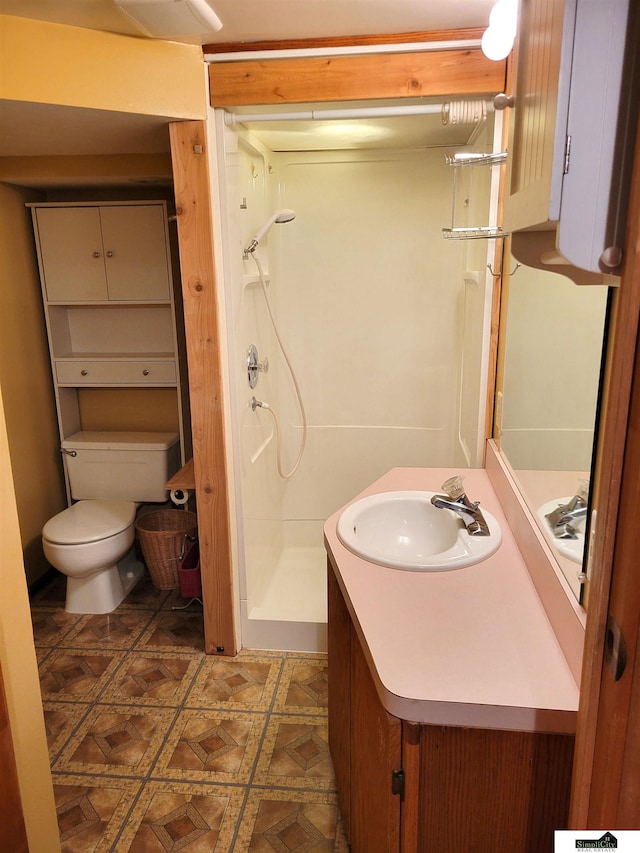 bathroom with walk in shower, vanity, and toilet