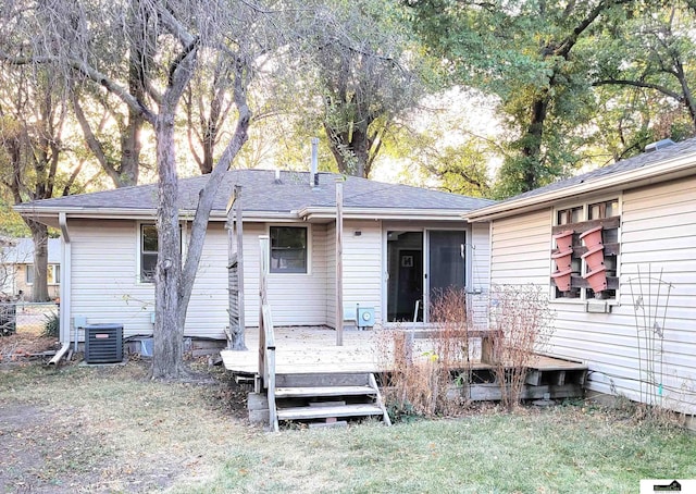 back of house featuring central AC unit, a yard, and a wooden deck