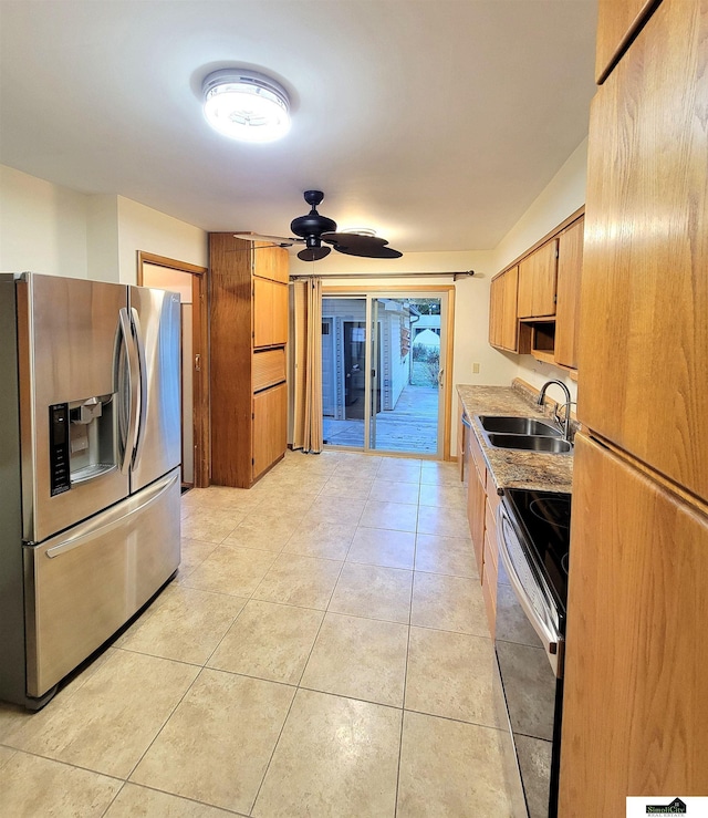 kitchen with sink, light tile patterned floors, stainless steel appliances, and ceiling fan