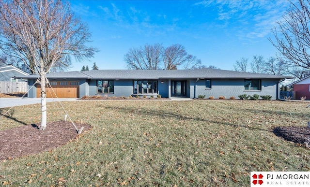 ranch-style house with a garage and a front lawn