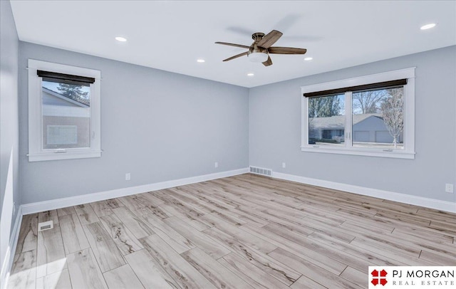 unfurnished room featuring ceiling fan, light hardwood / wood-style floors, and a healthy amount of sunlight