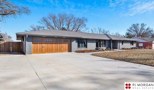 single story home with a garage and a front lawn