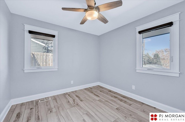 spare room featuring light hardwood / wood-style floors and ceiling fan