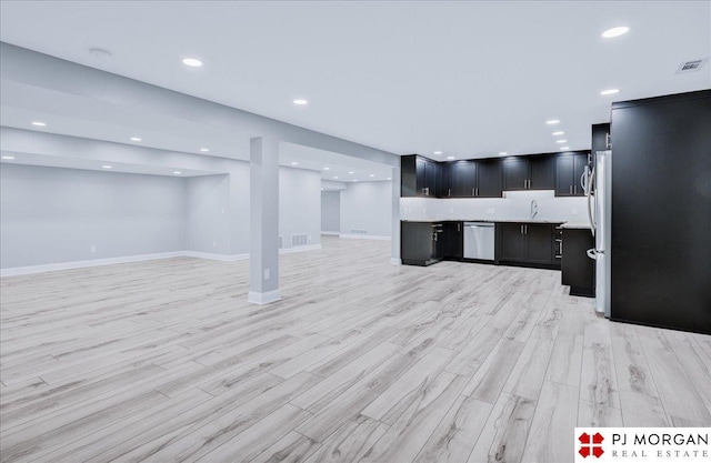 interior space with dishwasher, sink, and light hardwood / wood-style flooring