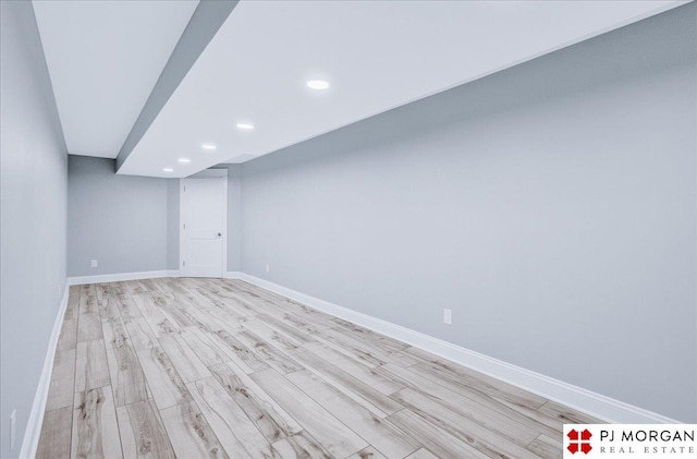 basement with light hardwood / wood-style floors