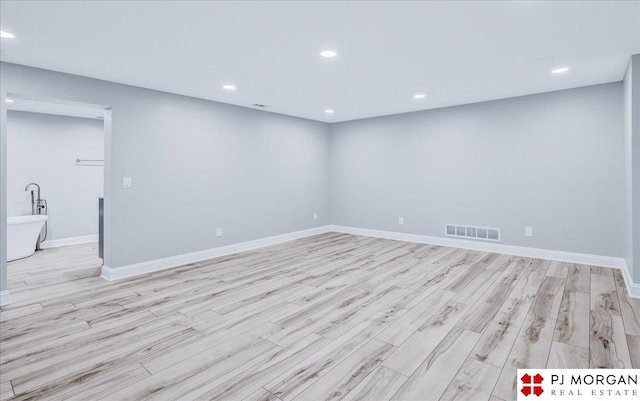 empty room with light hardwood / wood-style floors