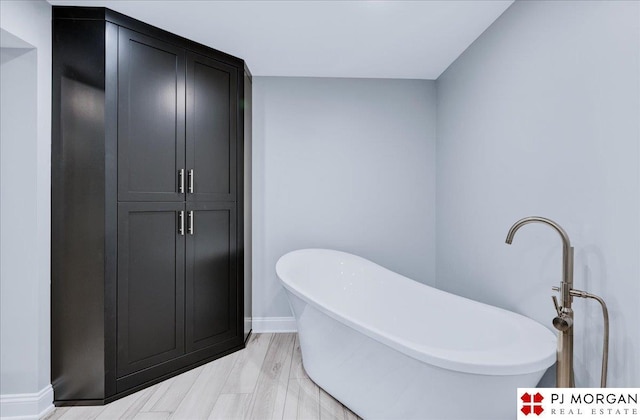 bathroom featuring a bathing tub and hardwood / wood-style floors