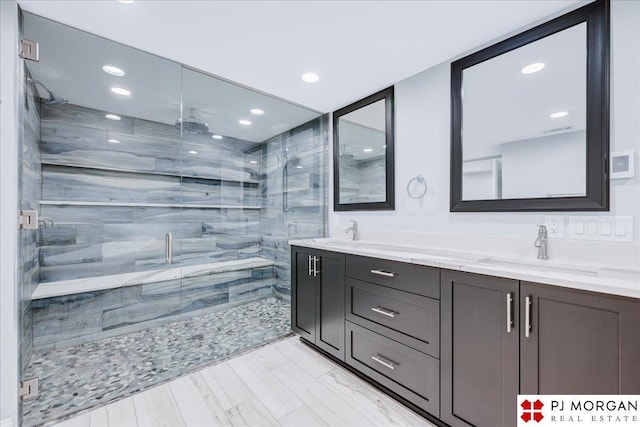 bathroom featuring vanity and a shower with shower door