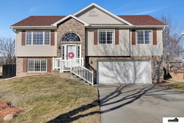 raised ranch with a garage and a front lawn