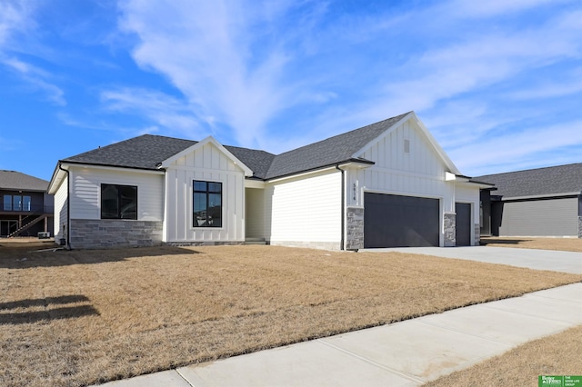 modern inspired farmhouse with a garage and a front yard