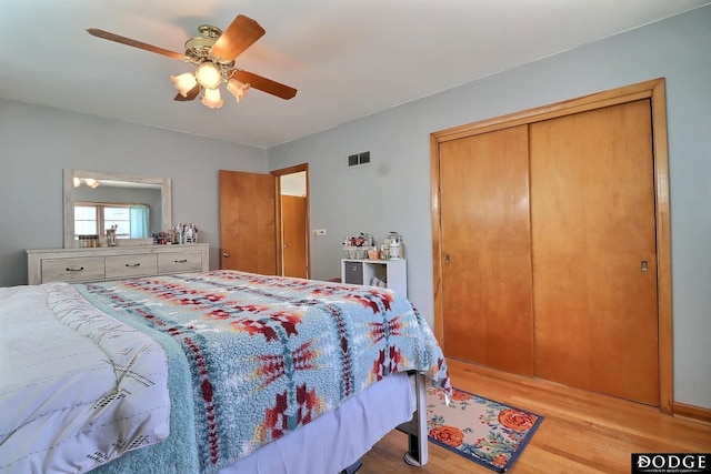 bedroom with light hardwood / wood-style flooring, a closet, and ceiling fan