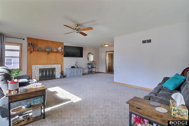 living room featuring ceiling fan, light colored carpet, and a fireplace