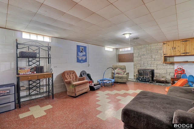 living room with plenty of natural light and a wood stove