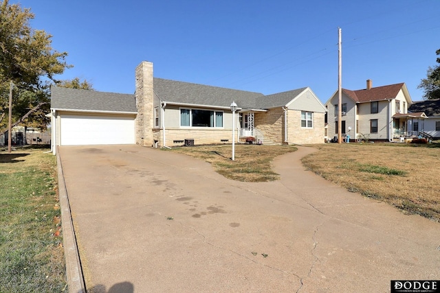 view of front of property with a garage and a front lawn