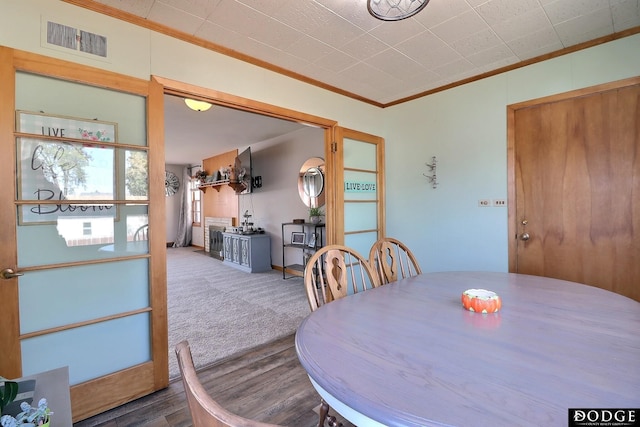 dining room featuring crown molding and carpet