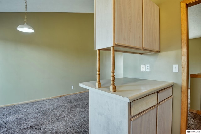 kitchen with light brown cabinetry, decorative light fixtures, lofted ceiling, and carpet flooring