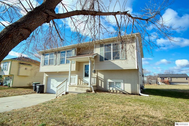 bi-level home featuring a garage and a front yard