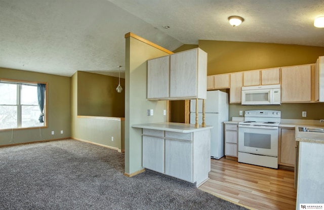 kitchen featuring vaulted ceiling, light brown cabinetry, hanging light fixtures, kitchen peninsula, and white appliances