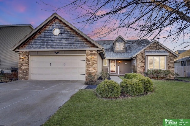 view of front of house with a garage and a yard