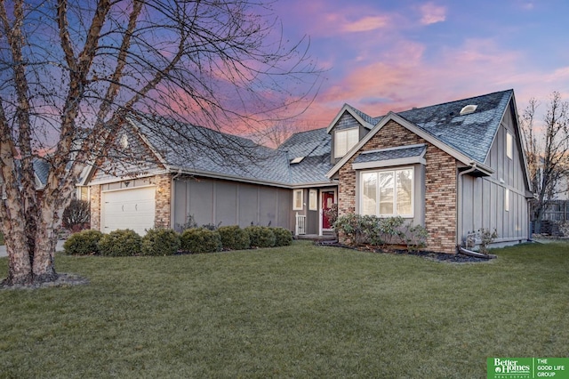 view of front of house with a garage and a yard