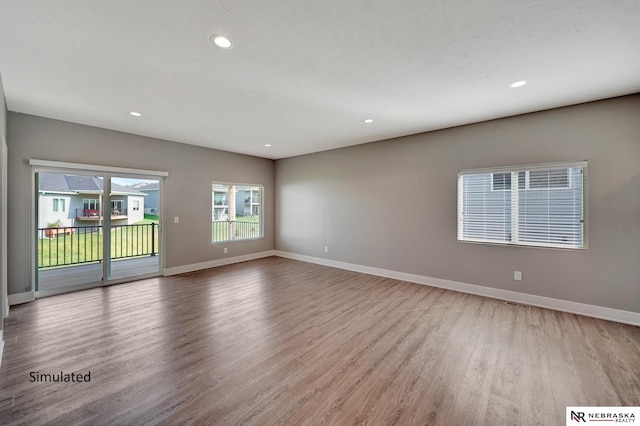 unfurnished room with light hardwood / wood-style floors