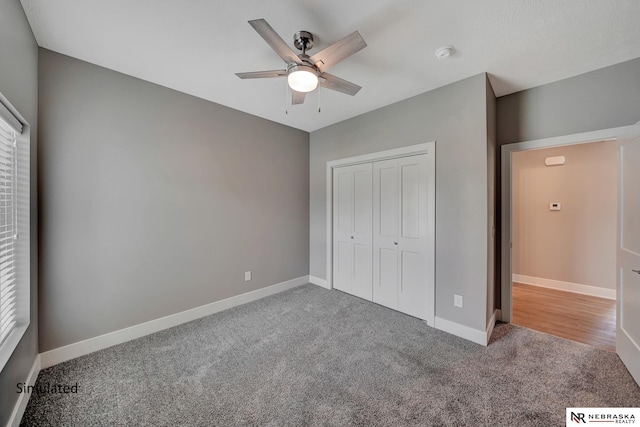 unfurnished bedroom with carpet, ceiling fan, and a closet