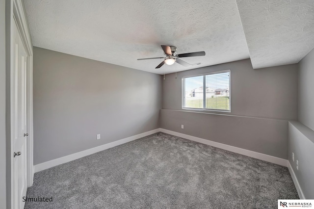 interior space featuring ceiling fan, carpet, and a textured ceiling