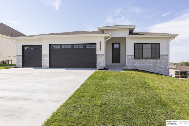 prairie-style home featuring a garage and a front lawn