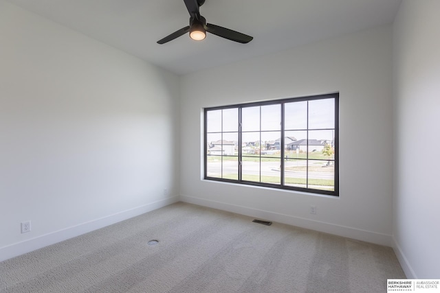 empty room with light carpet and ceiling fan