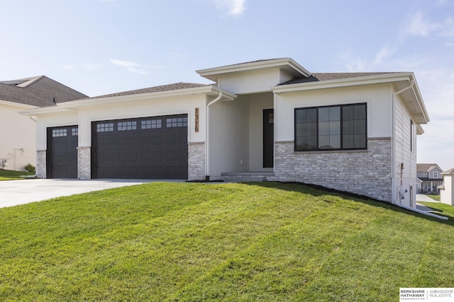 prairie-style house featuring a garage and a front lawn