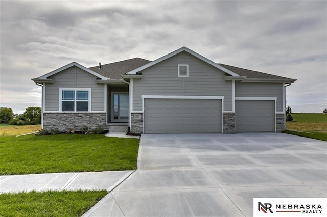 craftsman-style home featuring a garage and a front yard