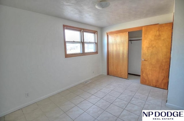 unfurnished bedroom with a closet