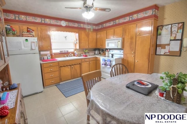 kitchen featuring ceiling fan, sink, and white appliances