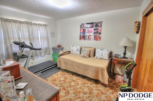 bedroom featuring carpet and a textured ceiling