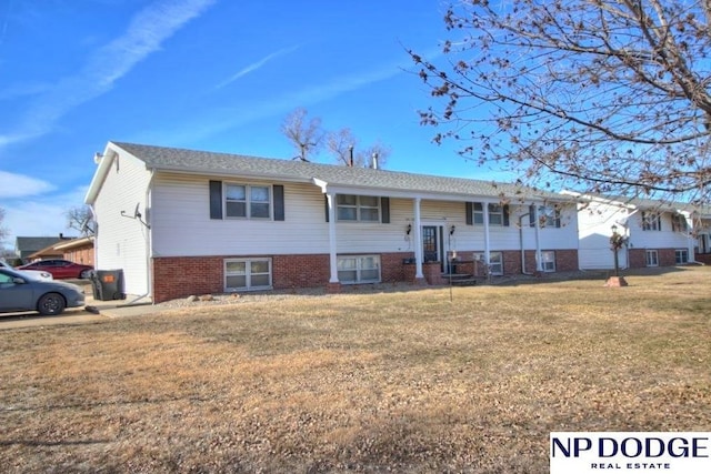 raised ranch featuring a front lawn