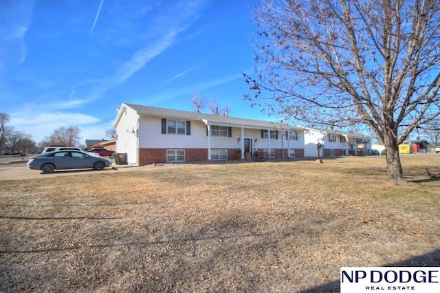 raised ranch with a front yard