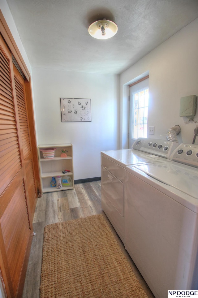 washroom featuring light hardwood / wood-style floors and washer and dryer